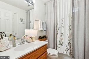 11050 Stonebrook Dr, Manassas, VA 20112 - bathroom featuring vanity, toilet, and a shower with curtain