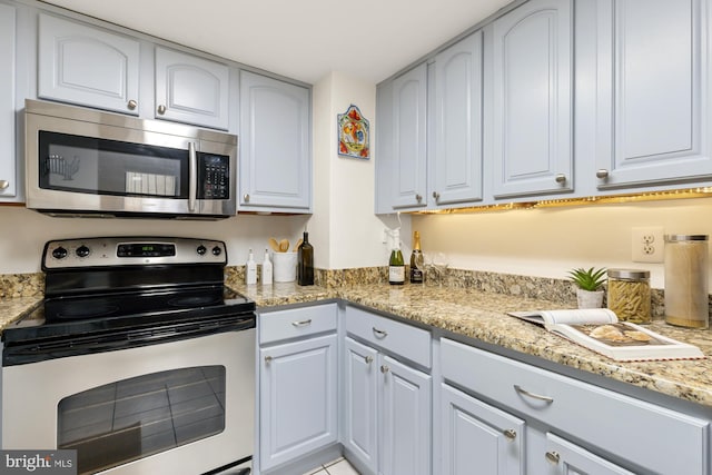 kitchen with stainless steel appliances and light stone counters