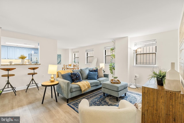 living room featuring light wood-type flooring and baseboards