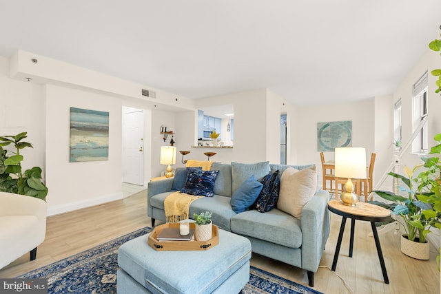 living area featuring wood finished floors and baseboards
