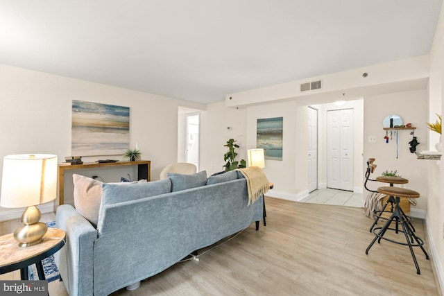 living area featuring light wood finished floors and baseboards