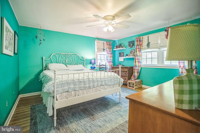 bedroom featuring baseboards, a ceiling fan, and wood finished floors