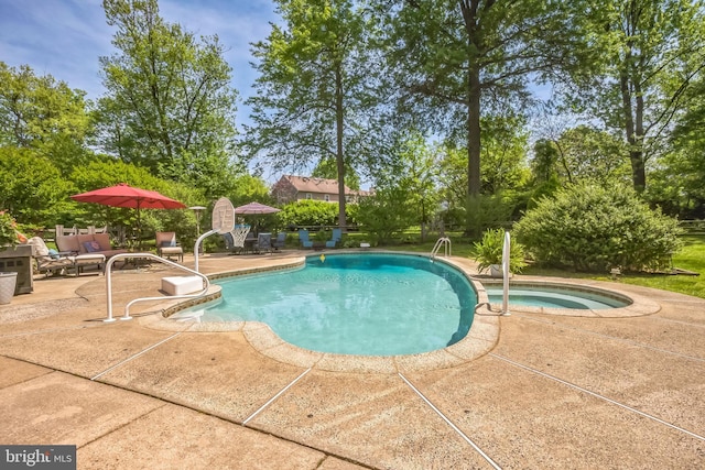 view of pool with a patio area and a pool with connected hot tub