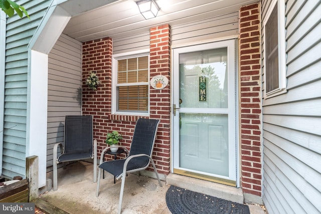 property entrance featuring brick siding