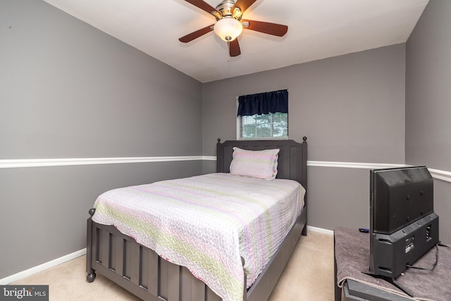carpeted bedroom with baseboards and ceiling fan