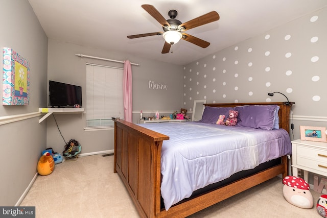 bedroom with light colored carpet, ceiling fan, and baseboards