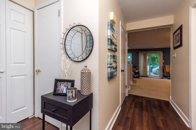 hall with wood finished floors and baseboards