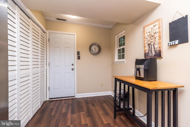 foyer with wood finished floors and baseboards