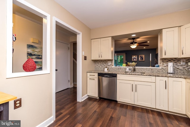 kitchen featuring stainless steel dishwasher, a sink, dark wood finished floors, tasteful backsplash, and ceiling fan
