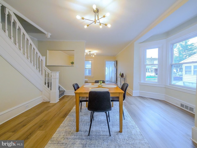 1008 Mcclenahan Ter, Marcus Hook, PA 19061 - dining room with a chandelier, stairs, wood finished floors, and baseboards