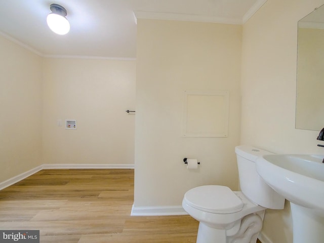 1008 Mcclenahan Ter, Marcus Hook, PA 19061 - bathroom featuring crown molding, wood finished floors, baseboards, toilet, and a sink