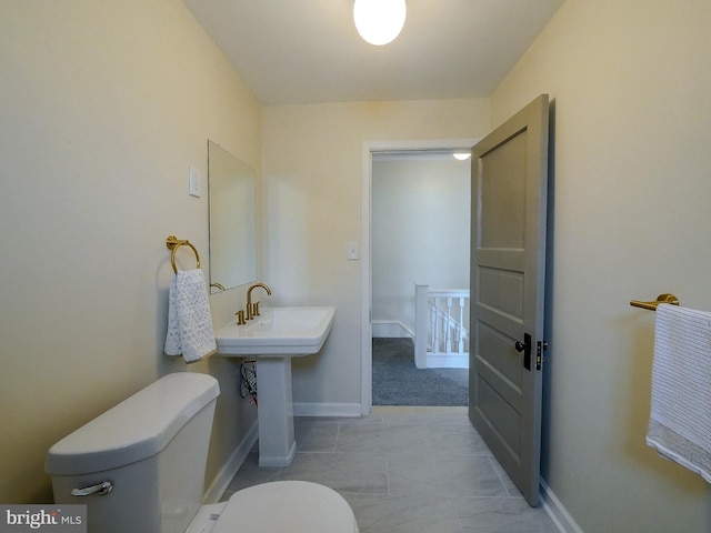 1008 Mcclenahan Ter, Marcus Hook, PA 19061 - bathroom with toilet, baseboards, and a sink