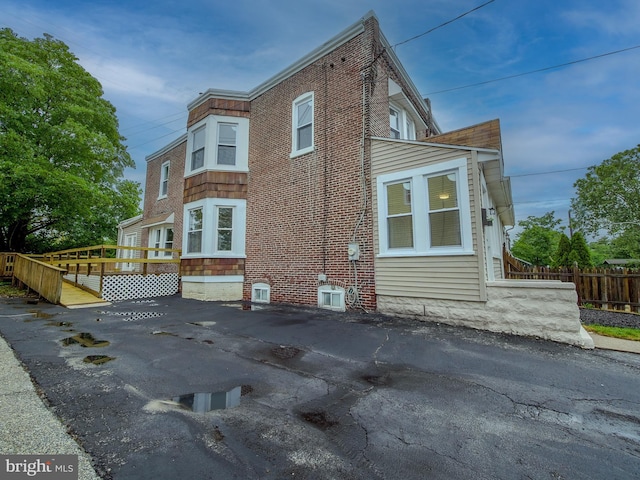 1008 Mcclenahan Ter, Marcus Hook, PA 19061 - view of side of home with fence and brick siding