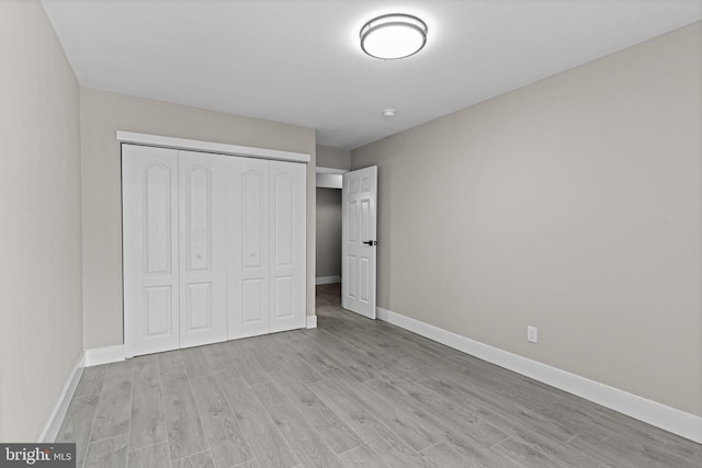 9001 Ridge Ave Unit 14, Philadelphia, PA 19128 - unfurnished bedroom featuring light wood-style flooring, a closet, and baseboards