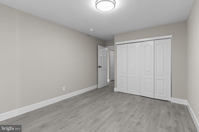 9001 Ridge Ave Unit 14, Philadelphia, PA 19128 - unfurnished bedroom featuring baseboards, light wood-type flooring, and a closet