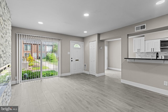 9001 Ridge Ave Unit 14, Philadelphia, PA 19128 - foyer with light wood-style floors, baseboards, and recessed lighting