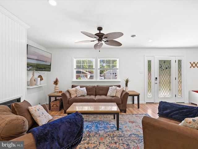 living room featuring ceiling fan, wood finished floors, recessed lighting, and a fireplace