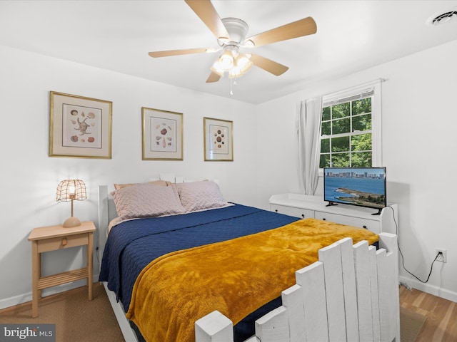 bedroom featuring baseboards, a ceiling fan, and light wood-style floors