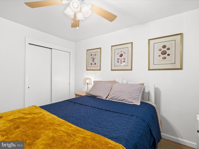 bedroom featuring a closet, baseboards, and ceiling fan