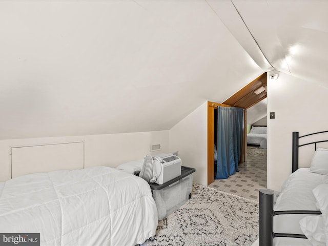 bedroom with lofted ceiling and tile patterned floors