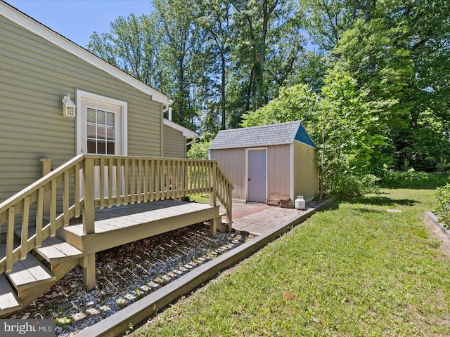 view of grassy yard with a shed and an outbuilding