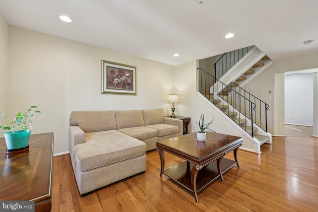 5737 Regency Ln, District Heights, MD 20747 - living area featuring wood finished floors, baseboards, stairway, and recessed lighting