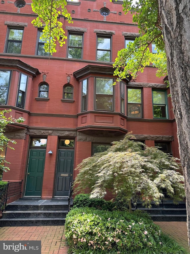 view of exterior entry with brick siding
