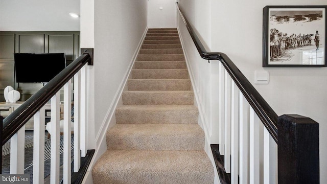 staircase with baseboards and recessed lighting