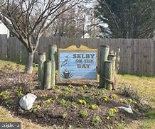community sign with fence