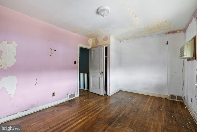 unfurnished room featuring hardwood / wood-style floors and baseboards