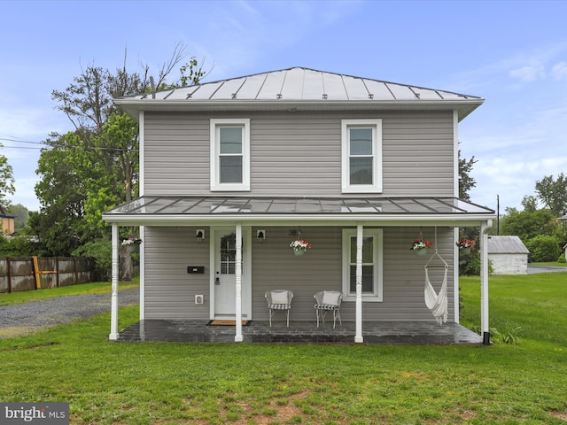 view of front facade with a standing seam roof, metal roof, and covered porch