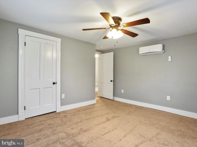 unfurnished bedroom featuring a wall mounted AC, carpet flooring, baseboards, and a ceiling fan