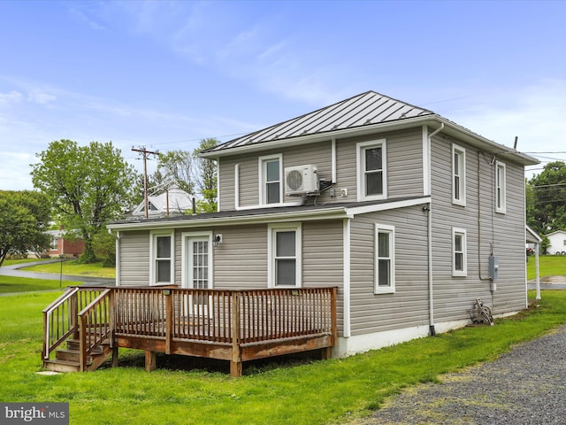 back of house featuring a standing seam roof, a wooden deck, ac unit, metal roof, and a lawn