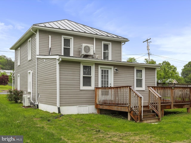 back of property featuring a standing seam roof, a cooling unit, a yard, a deck, and metal roof