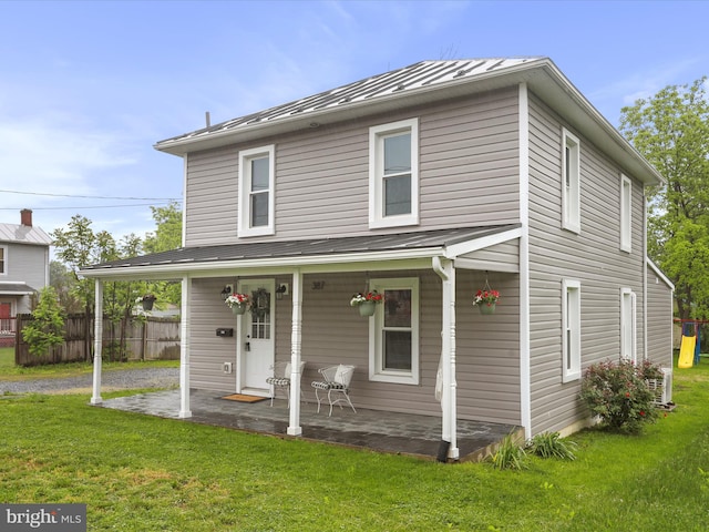 view of front of home with a standing seam roof, covered porch, and metal roof