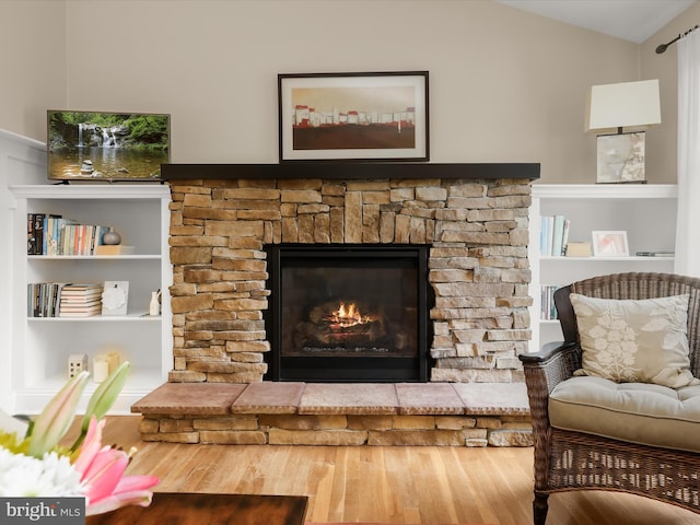 101 Gothard Rd, Lutherville Timonium, MD 21093 - living room featuring wood finished floors, a stone fireplace, vaulted ceiling, and built in shelves