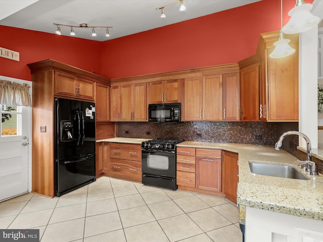 101 Gothard Rd, Lutherville Timonium, MD 21093 - kitchen with black appliances, a sink, light tile patterned floors, and brown cabinetry