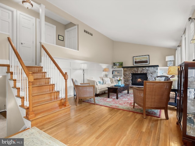 101 Gothard Rd, Lutherville Timonium, MD 21093 - living room with light wood finished floors, vaulted ceiling, stairs, and a fireplace