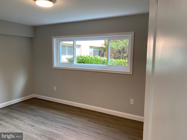 3419 University Blvd W Unit 102, Kensington, MD 20895 - unfurnished room with healthy amount of natural light, dark wood-style floors, and baseboards