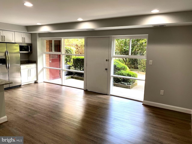 3419 University Blvd W Unit 102, Kensington, MD 20895 - unfurnished living room with plenty of natural light, dark wood-style flooring, recessed lighting, and baseboards