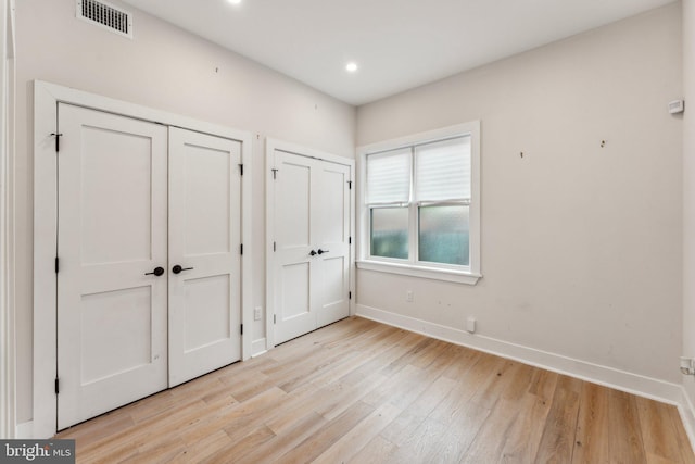 1645 W Virginia NE Unit 1, Washington, DC 20002 - unfurnished bedroom with multiple closets, baseboards, light wood-type flooring, and recessed lighting