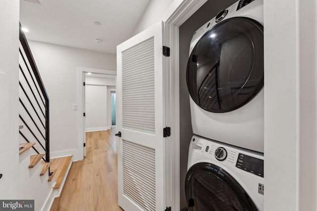 1645 W Virginia NE Unit 1, Washington, DC 20002 - laundry area with estacked washer and dryer, light wood finished floors, and baseboards