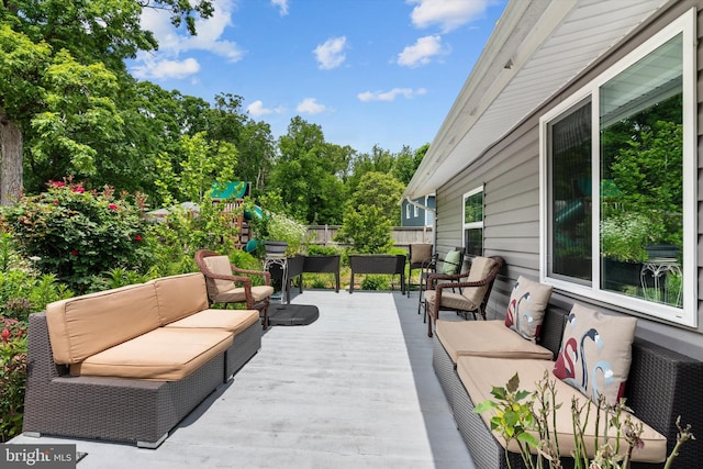 10412 Midway Ln, Lorton, VA 22079 - wooden terrace featuring outdoor lounge area, fence, and view of wooded area