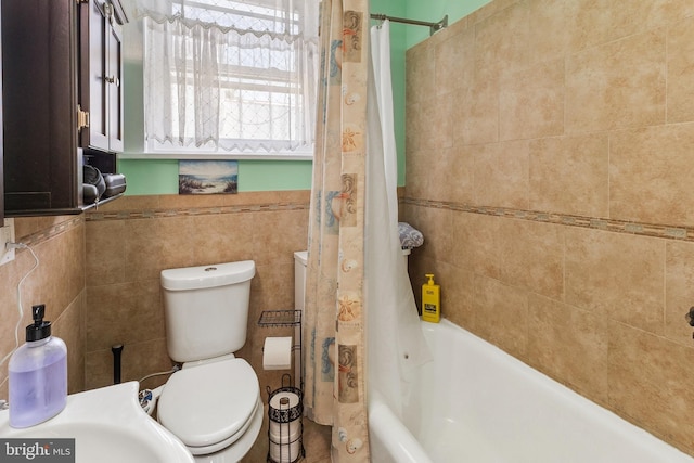 full bathroom with toilet, tile walls, and shower / tub combo