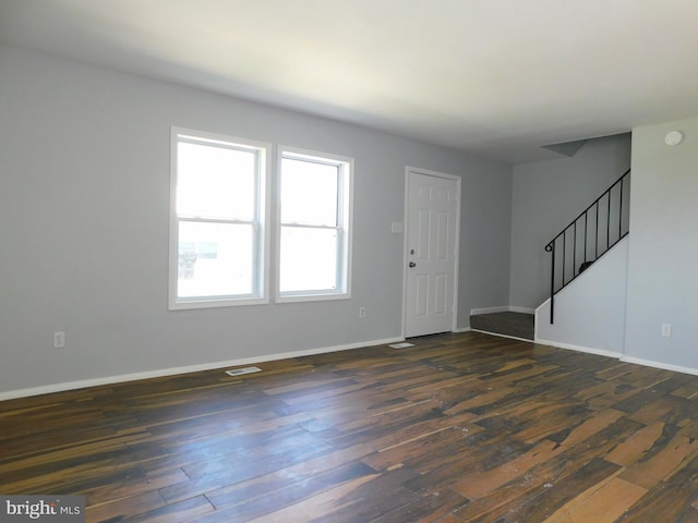 foyer featuring stairway, baseboards, and dark wood-type flooring