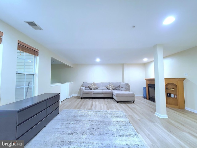 29 Ferns Ct, Lutherville Timonium, MD 21093 - living area featuring light wood-style floors, a glass covered fireplace, baseboards, and recessed lighting