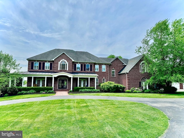 8170 Hollow Rd, Middletown, MD 21769 - view of front facade featuring curved driveway, a front lawn, brick siding, and french doors