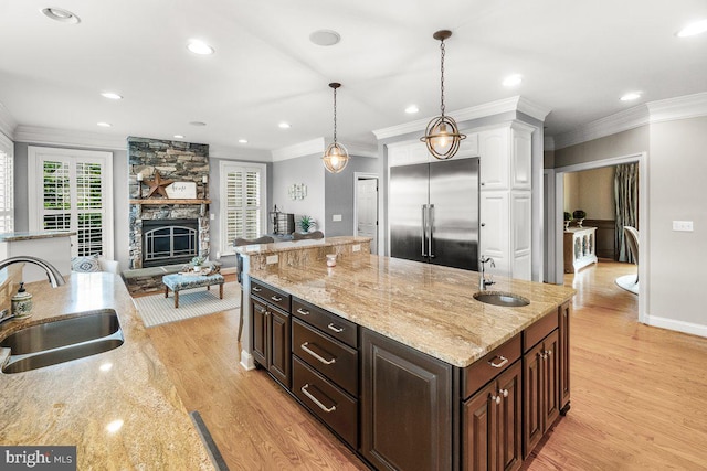 8170 Hollow Rd, Middletown, MD 21769 - kitchen with a sink, built in fridge, white cabinets, light wood-style floors, and ornamental molding