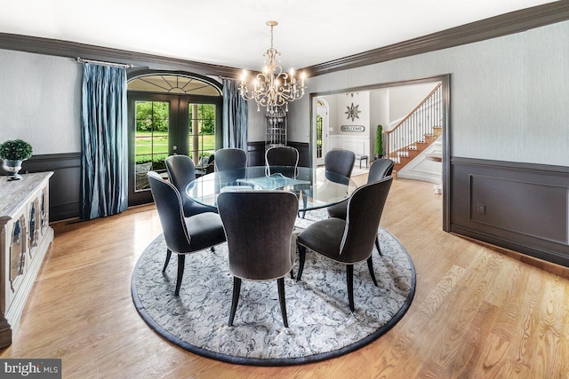 8170 Hollow Rd, Middletown, MD 21769 - dining area featuring french doors, a chandelier, ornamental molding, stairway, and light wood-style floors