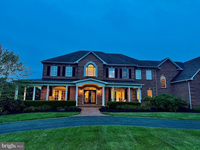 8170 Hollow Rd, Middletown, MD 21769 - view of front of home with french doors, brick siding, a front yard, and a porch